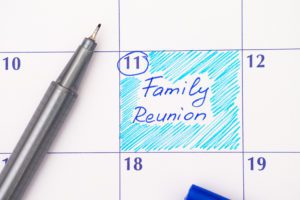 Paper calendar with handwritten reminder of family reunion.