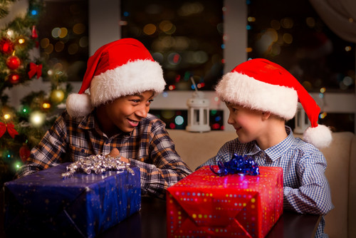 Christmas Cruises - Two Mischievous boys with santa hats and gifts