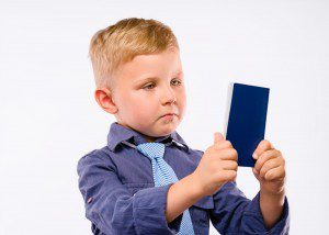 Family Passports - Photo of young boy staring glumly at passport