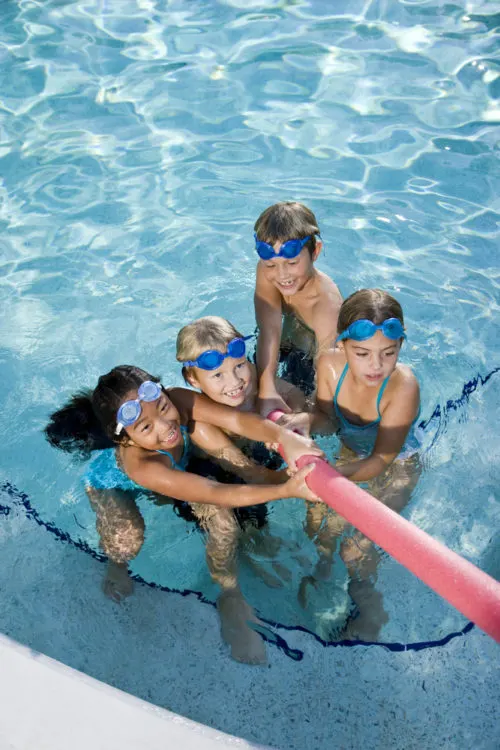 Water safety for kids - photo of group of kids playing with pool noodle