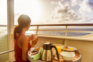 Choosing a cruise cabin-woman served breakfast on suite verandah