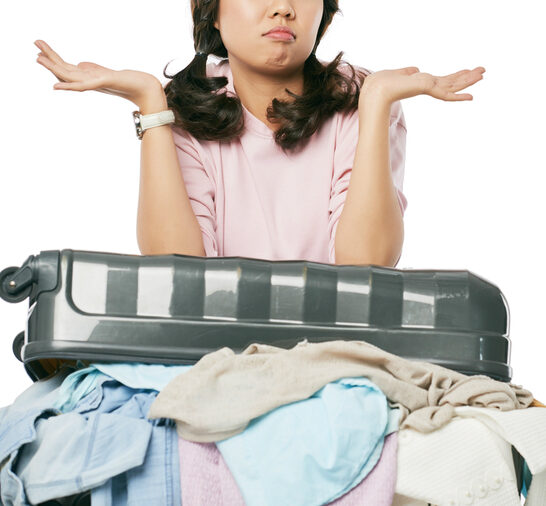 Laundry on a cruise ship - photo of woman with overstuffed suitcase