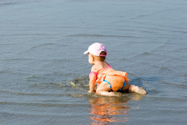 Best cruises for toddlers - photo of baby in shallow water at beach