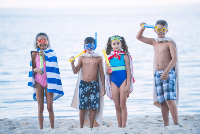 Cruise Packing List | Packing for a cruise - photo of group of kids playing with fun gear on beach