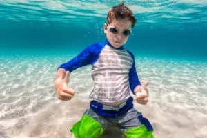 Packing for a cruise - photo of boy underwater in swim goggles.