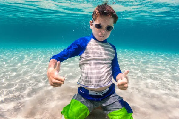 Packing for a Caribbean cruise - photo of boy underwater in swim goggles.