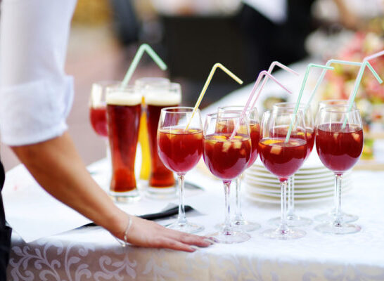 Cruise Drinks Package -Waitress holding a dish of sangria glasses