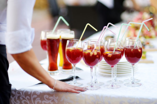 Cruise Drinks Package -Waitress holding a dish of sangria glasses