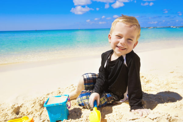 Family Cruise Port Calls | photo of small boy playing on beach with sand toys