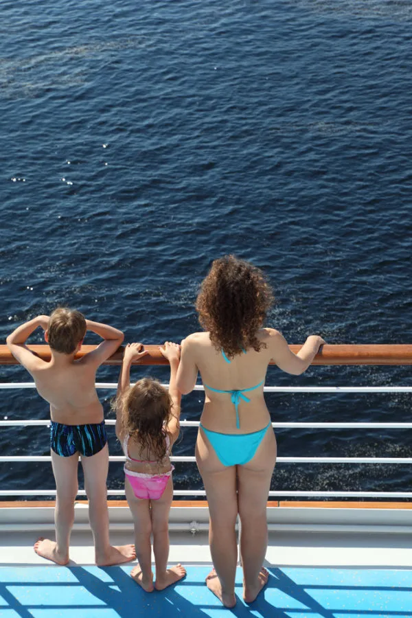 cruise mistakes | family staring over railing of ship