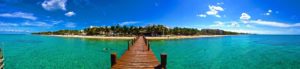 Cruise Shore Excursions | panoramic photo of long pier leading to tropical island