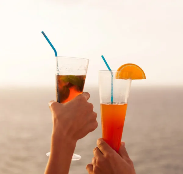 NCL Beverage Package | photo of hands holding cocktails