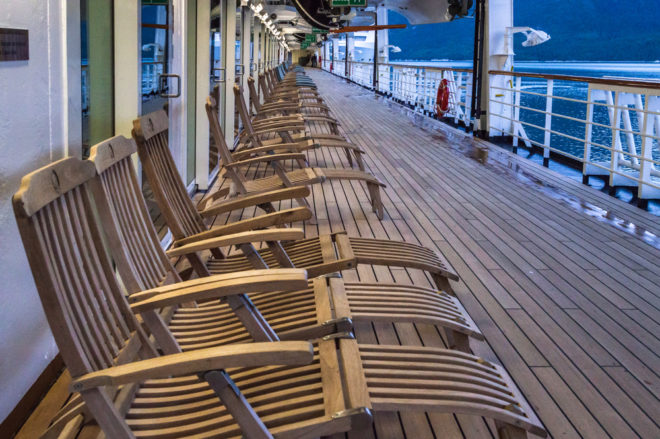 Best Alaskan Cruises For Families | photo Row of cruise ship empty wooden outdoor deck chairs 