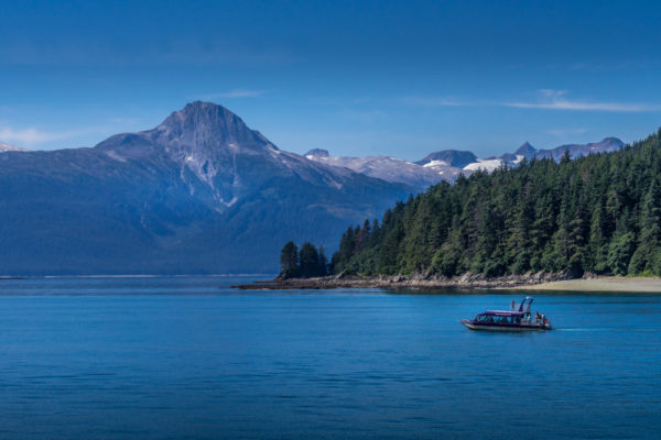 Alaska Cruise Excursions | photo of small whale watching boat sailing across bay