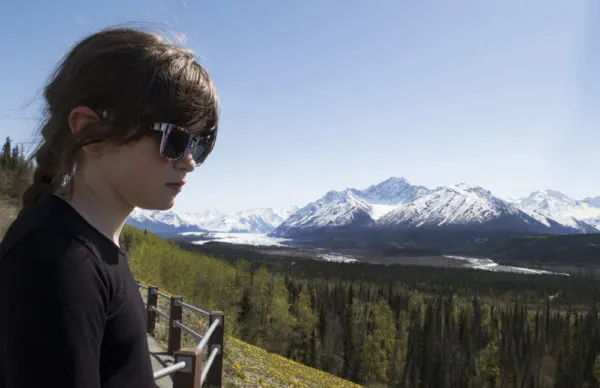 What to pack for an Alaska cruise | girl in sunglasses taking in landscape