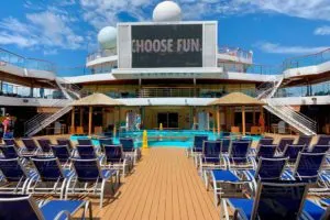 Embarkation Tips | photo empty seats lined up by cruise ship pool