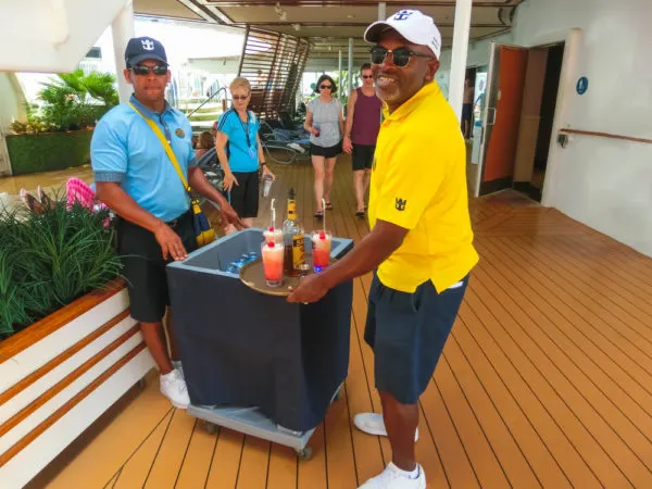 Cruise Carry On Essentials | photo of cruise personnel assisting passengers with drinks