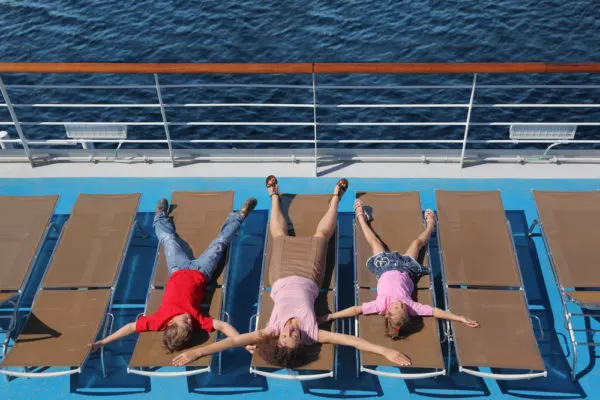 Carry On Cruise Bag | photo of family playing around on open air deck chairs