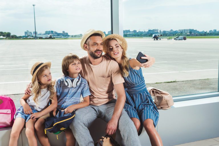 Family Travel Hacks | photo of family in airport taking selfie