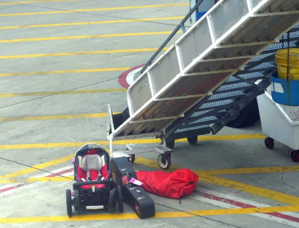 Travel Packing Tips | photo of forlorn car seat left on tarmac