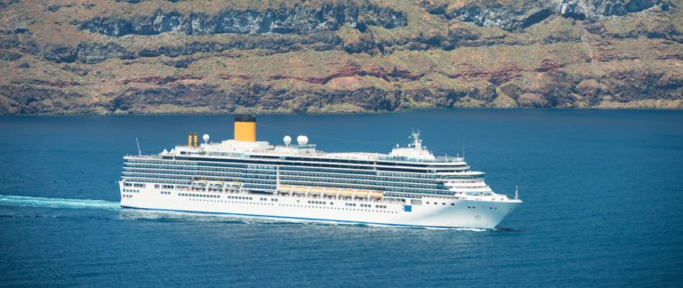 How Fast Does a Cruise Ship Go? | Photo of ship sailing past Greece coast line