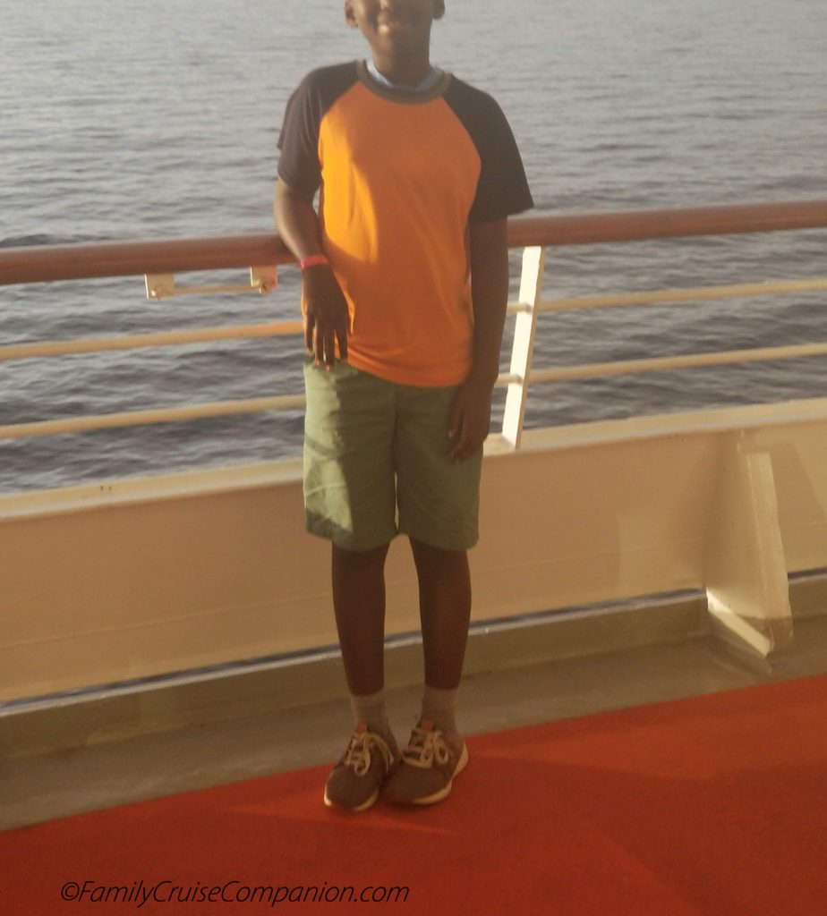 How Does Someone Fall Off A Cruise Ship? | photo of tall boy next to high railing
