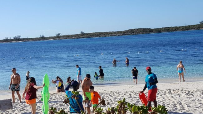Things to Do In Nassau Bahamas For Families | photo of families frolicking on the beach in the Bahamas.