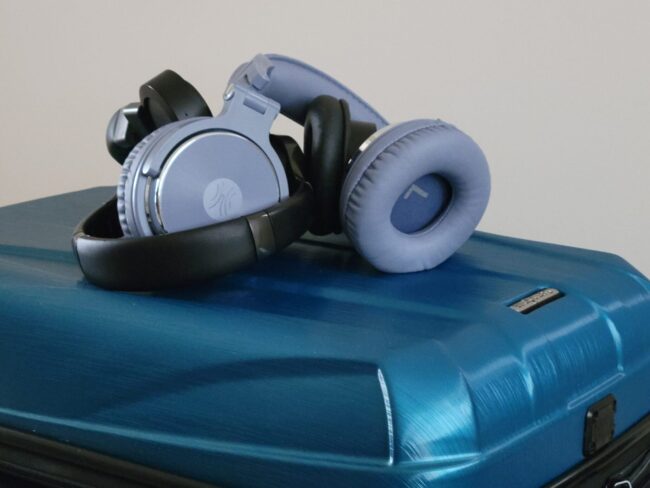 Lightweight Wireless Headphones | photo of wireless headphones stacked on suitcase