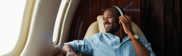 How Do Wireless Headphones Work | photo of happy many with wireless headphones on plane