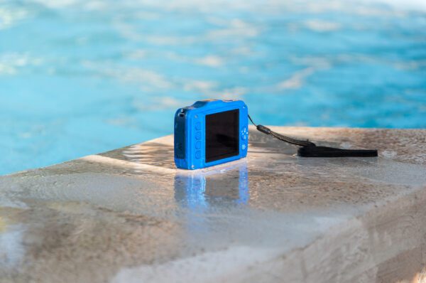 A waterproof camera getting splashed on side of pool.