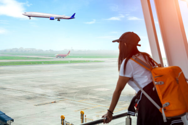 What to do if you missed your connecting flight | photo of girl watching her flight depart