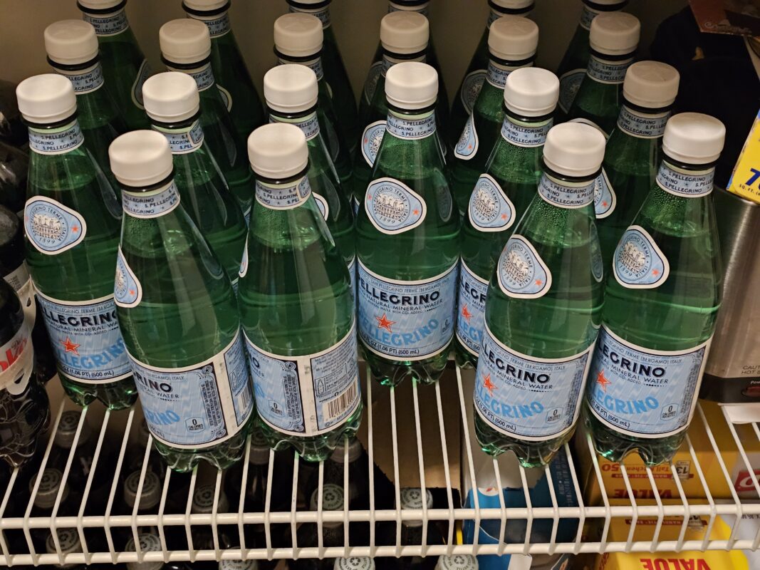 Close-up of sealed plastic San Pellegrino water bottles, which may be banned from cruise carry-ons due to container policies.