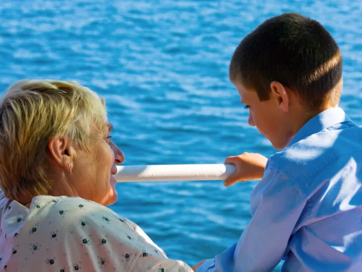 Mutigenerational Cruise Trends | photo of grandma chatting with grandson next to ship's railing.
