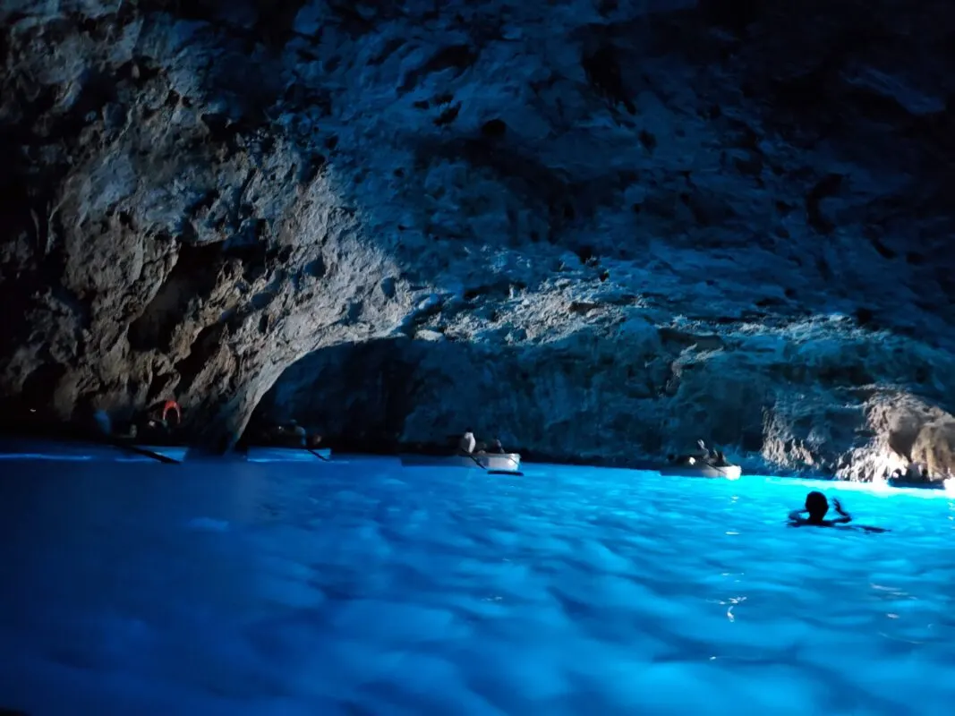 Photo: Inside the Blue Grotto with rowboats circling the perimeter of the cavern.