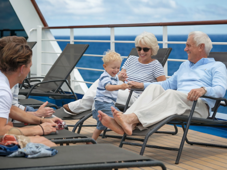 Cruise the Caribbean | grandparents lounging on deck of cruise ship with their kids and grandchild