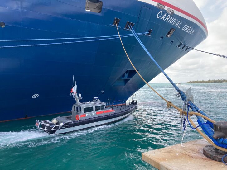 What is a Ship Pilot | photo of pilot ship lining up next to cruise ship