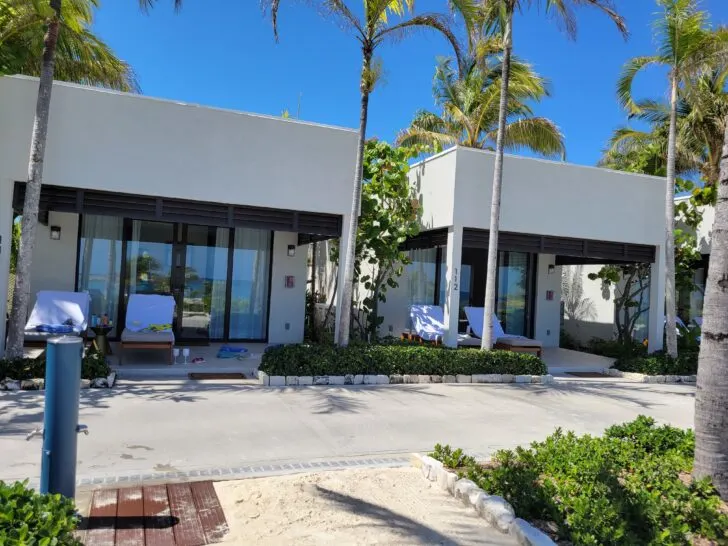 Photo of two side-by-side upscale luxury beach cabanas on Norwegian's private island, Harvest Caye. These air-conditioned cabanas feature private terrace and sliding glass doors.