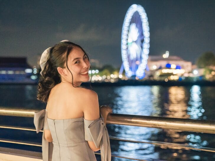 Cruises with overnight stays | Passenger enjoying view of night Ferris wheel from ship deck