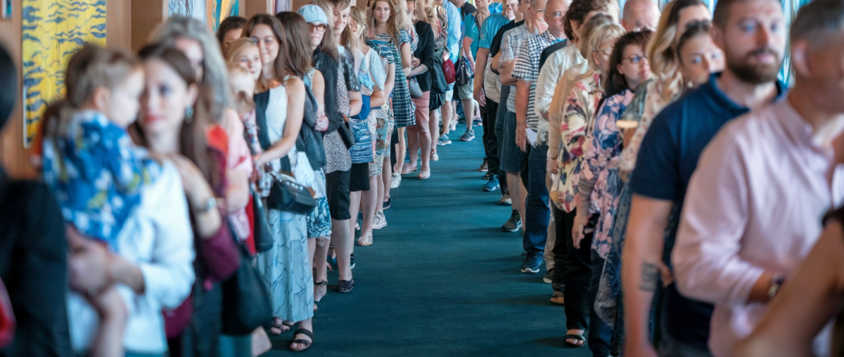 Representation of crowd of cruise passengers standing in line for dining room seating.