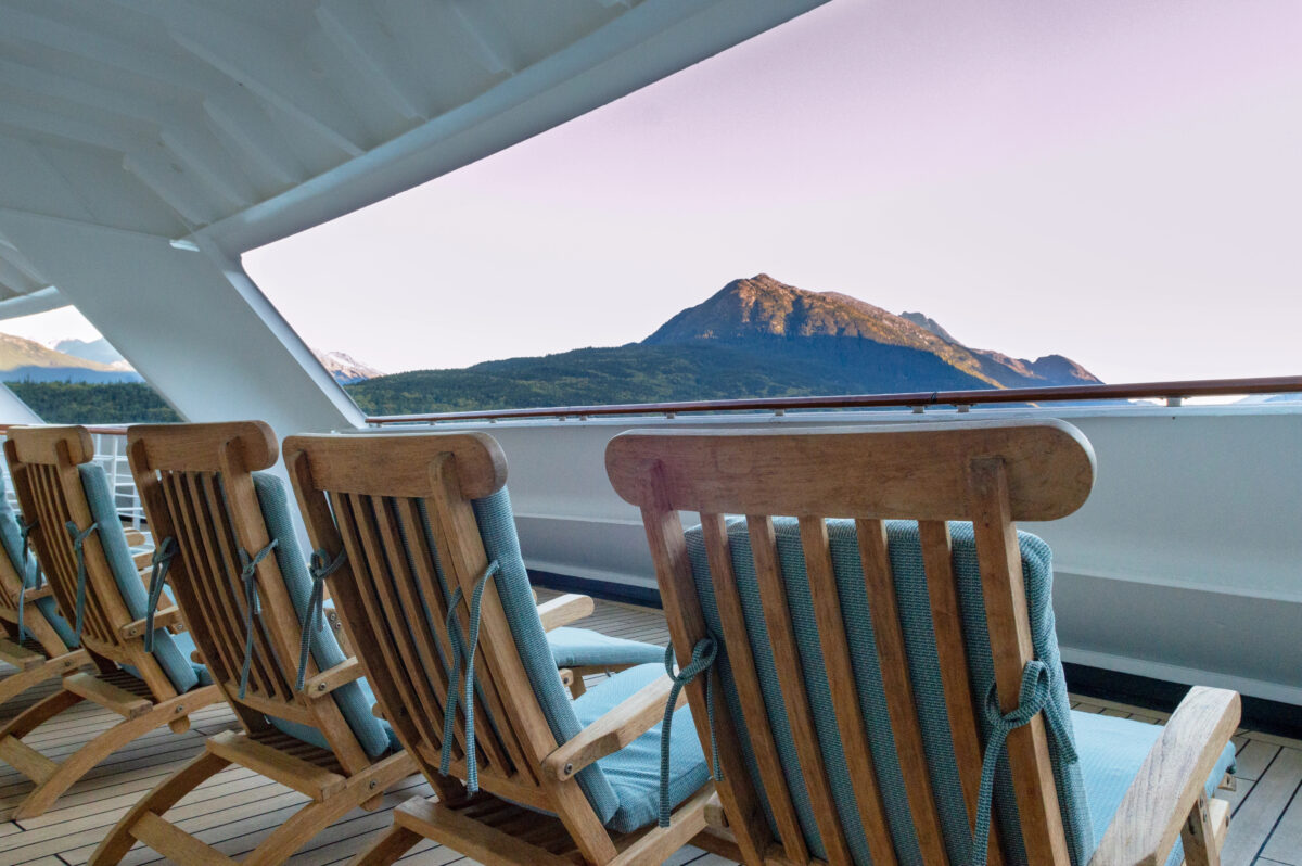 A quiet viewing area with lounge chairs on a cruise ship offers a stunning alternative for those debating the best cabin for an Alaska cruise.