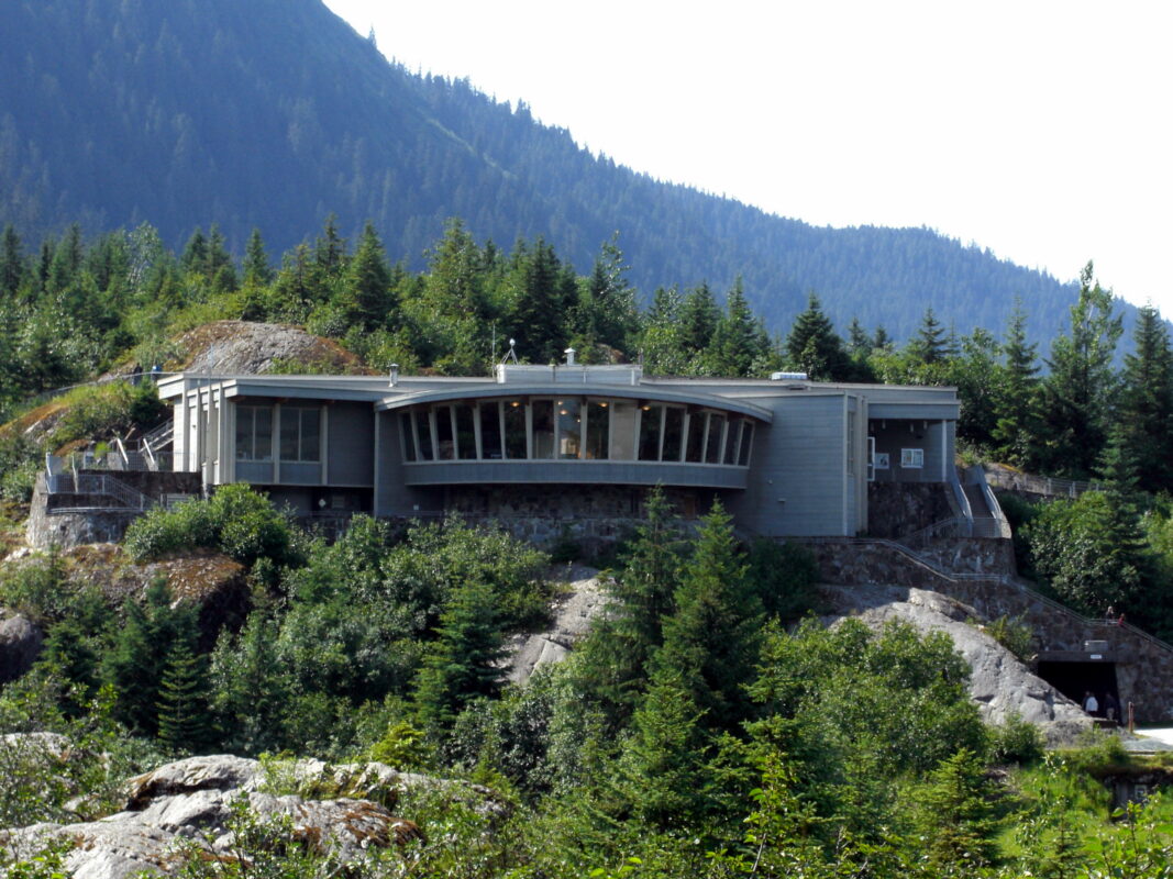 A modern visitor center perched on a rocky hillside, providing educational displays and panoramic glacier views, making it a great option for family activities in Juneau.