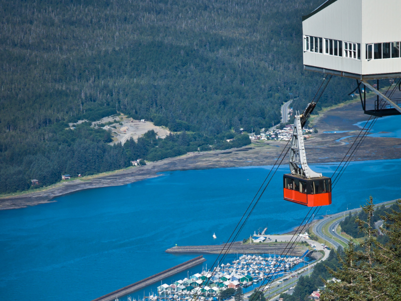 The Goldbelt Tramway in Juneau, Alaska, carrying passengers high above the waterfront, is one of the top family activities in Juneau, offering incredible views of the mountains and harbor.