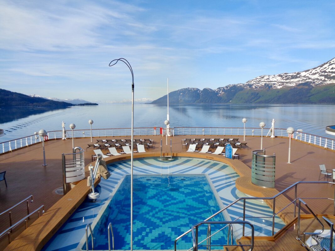 The ship’s pool deck provides a spacious, open-air setting with uninterrupted glacier views, proving that public spaces can rival the best balcony cabin for an Alaska cruise.