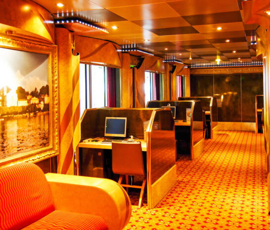 Old-style cruise ship internet café with desktop computer workstations in a quiet lounge