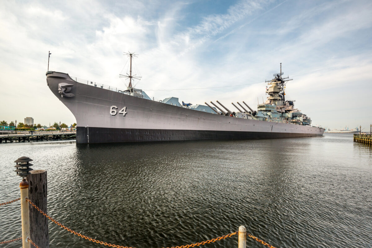 Large historic battleship moored at the waterfront in Norfolk near the cruise port.