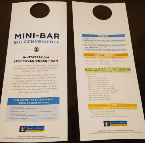 Photo of Royal Caribbean’s in-room mini-bar beverage order form listing prices for bottled water, soft drinks, and energy drinks—an option to consider when evaluating if a Royal Caribbean drink package is worth it.