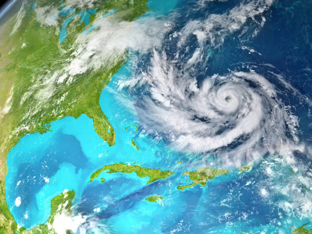 Satellite image of a large hurricane swirling over the Atlantic Ocean near the southeastern U.S. and the Caribbean.