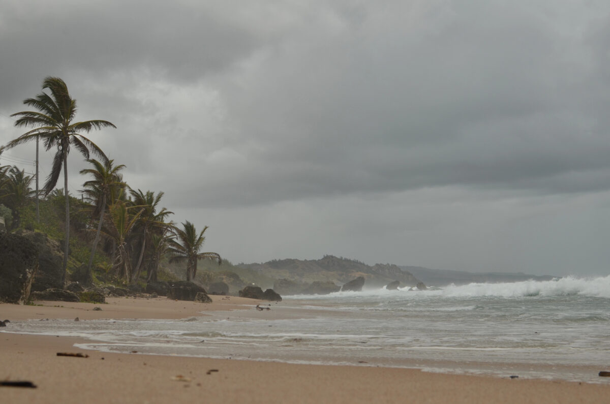 A stormy beach in Barbados with rough waves and gray skies during hurricane season in the southern Caribbean.