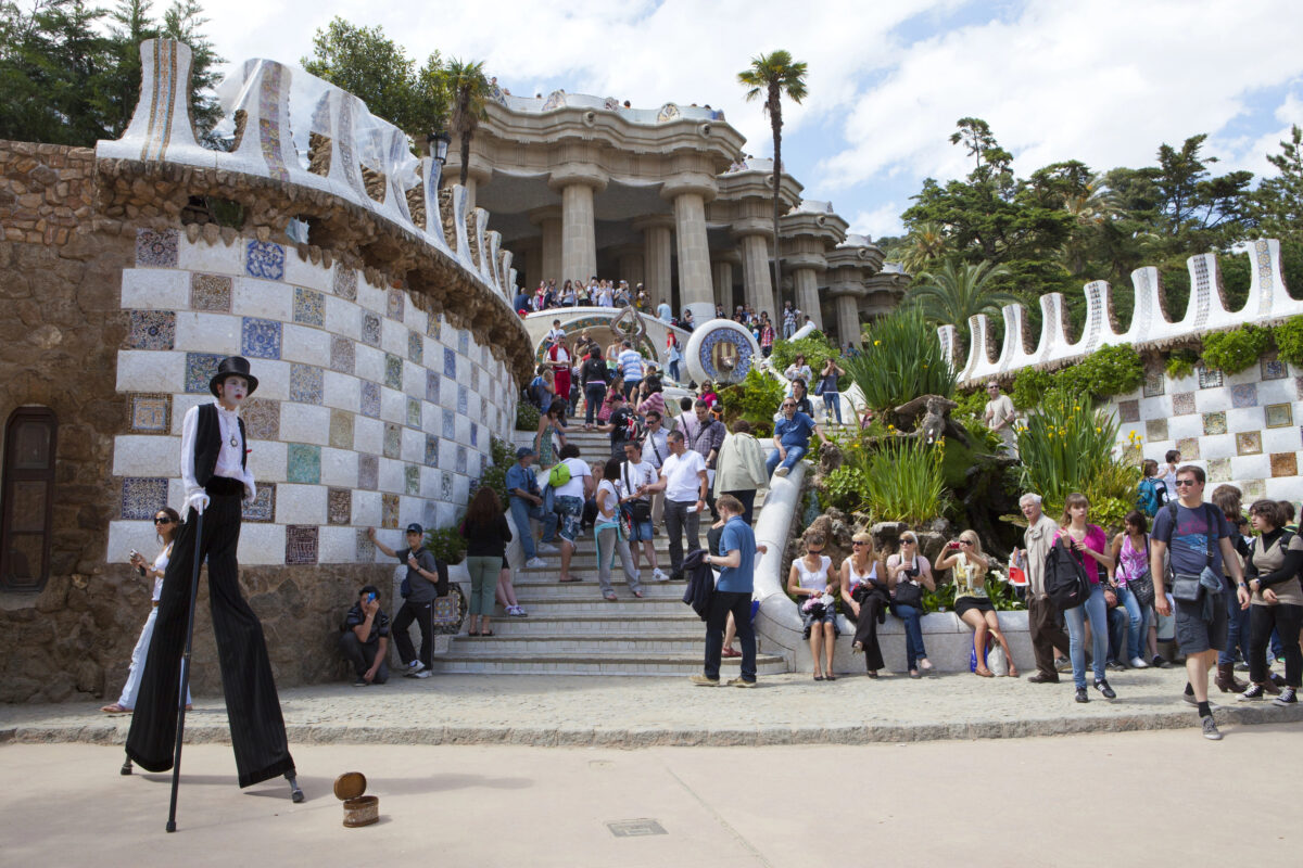 Large crowds of tourists at Park Güell in Barcelona, with visitors packing the steps and pathways, showing how popular Mediterranean cruise excursions can feel overwhelming.