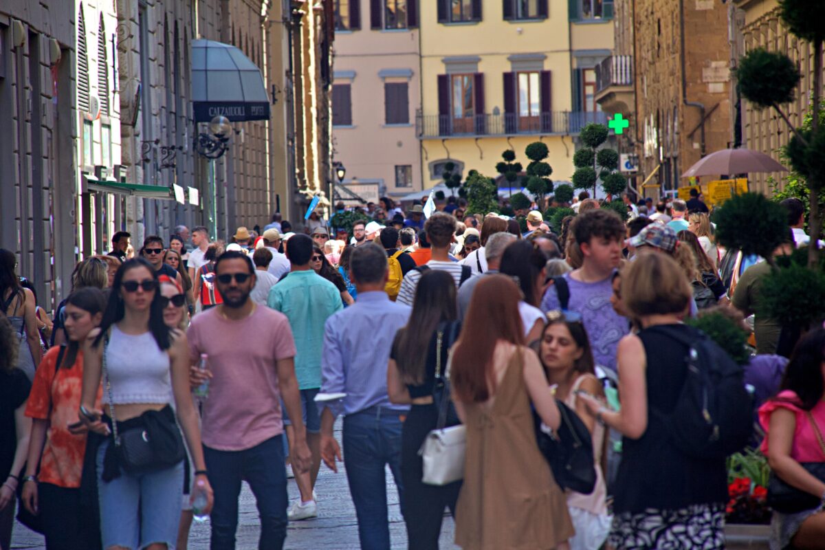 Busy summer day in Florence with people packed into historic streets, illustrating how sightseeing can be exhausting.